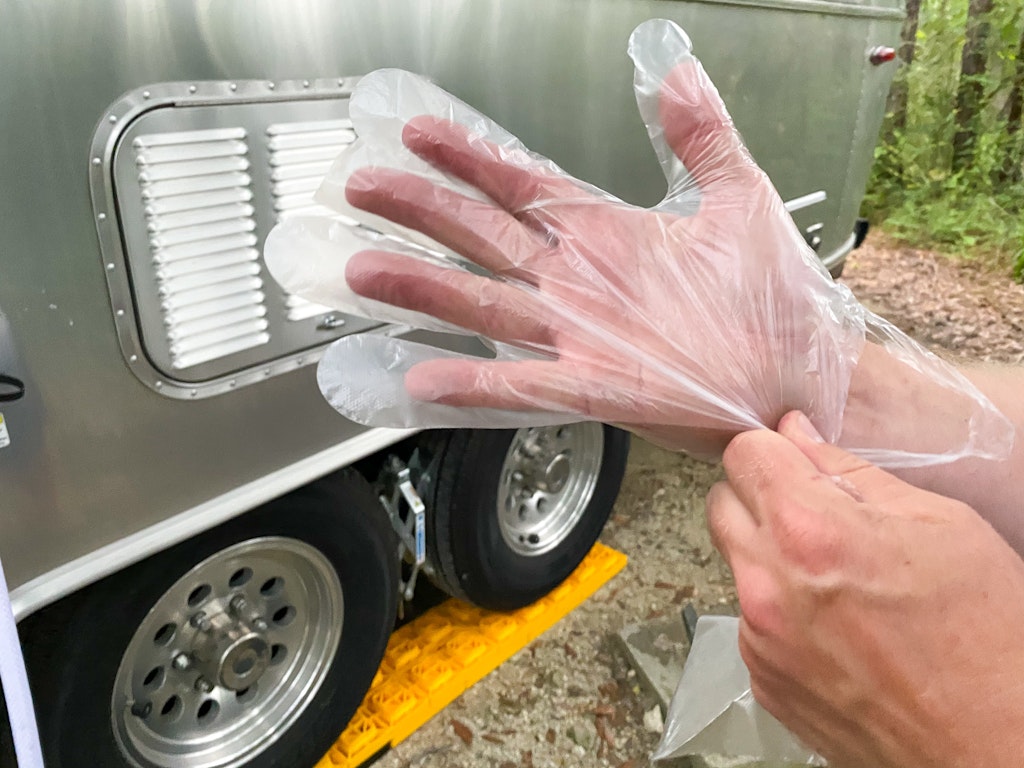 setting up campsite RV connecting sewer hose