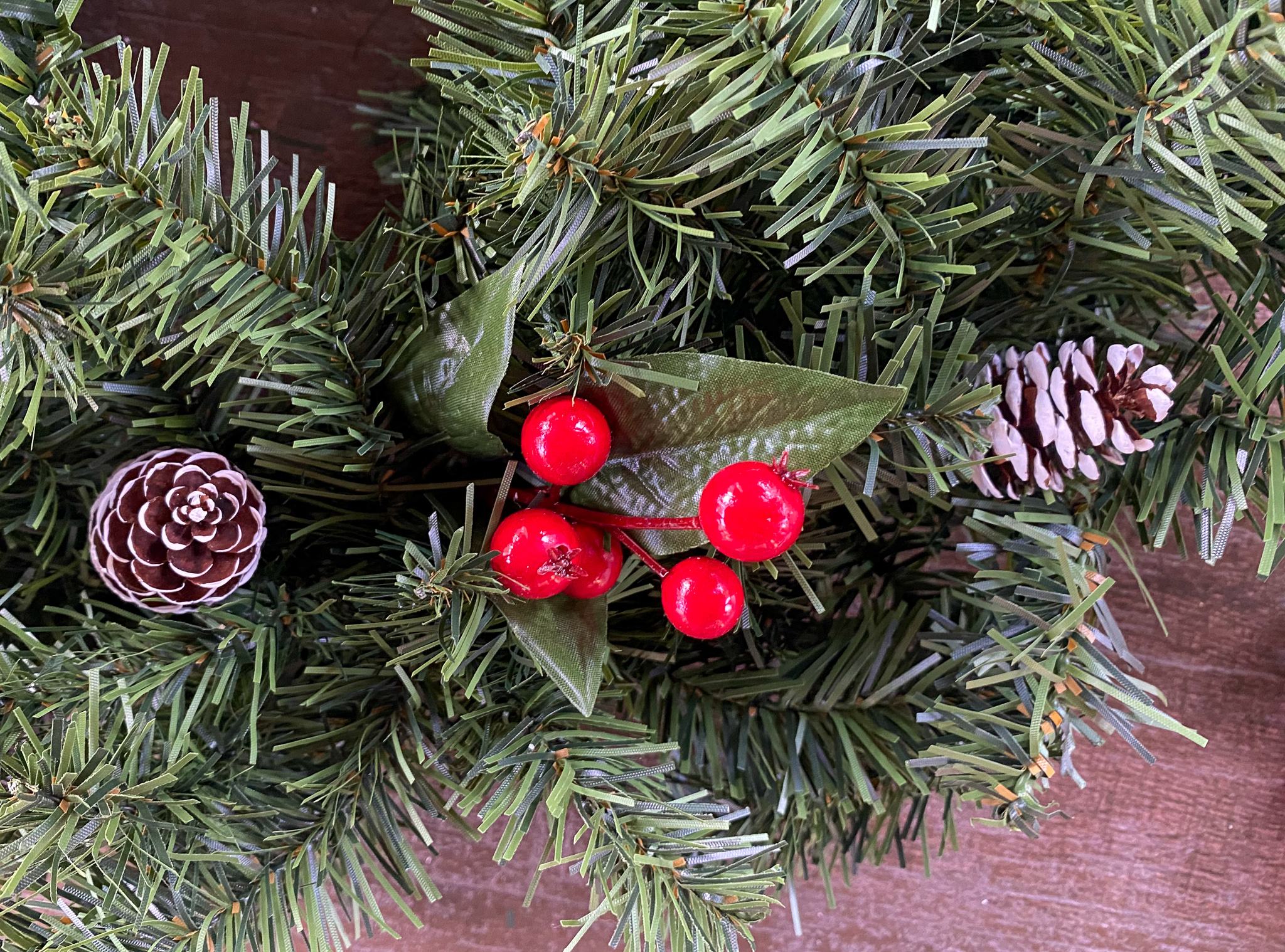adding decorations to christmas. wreath
