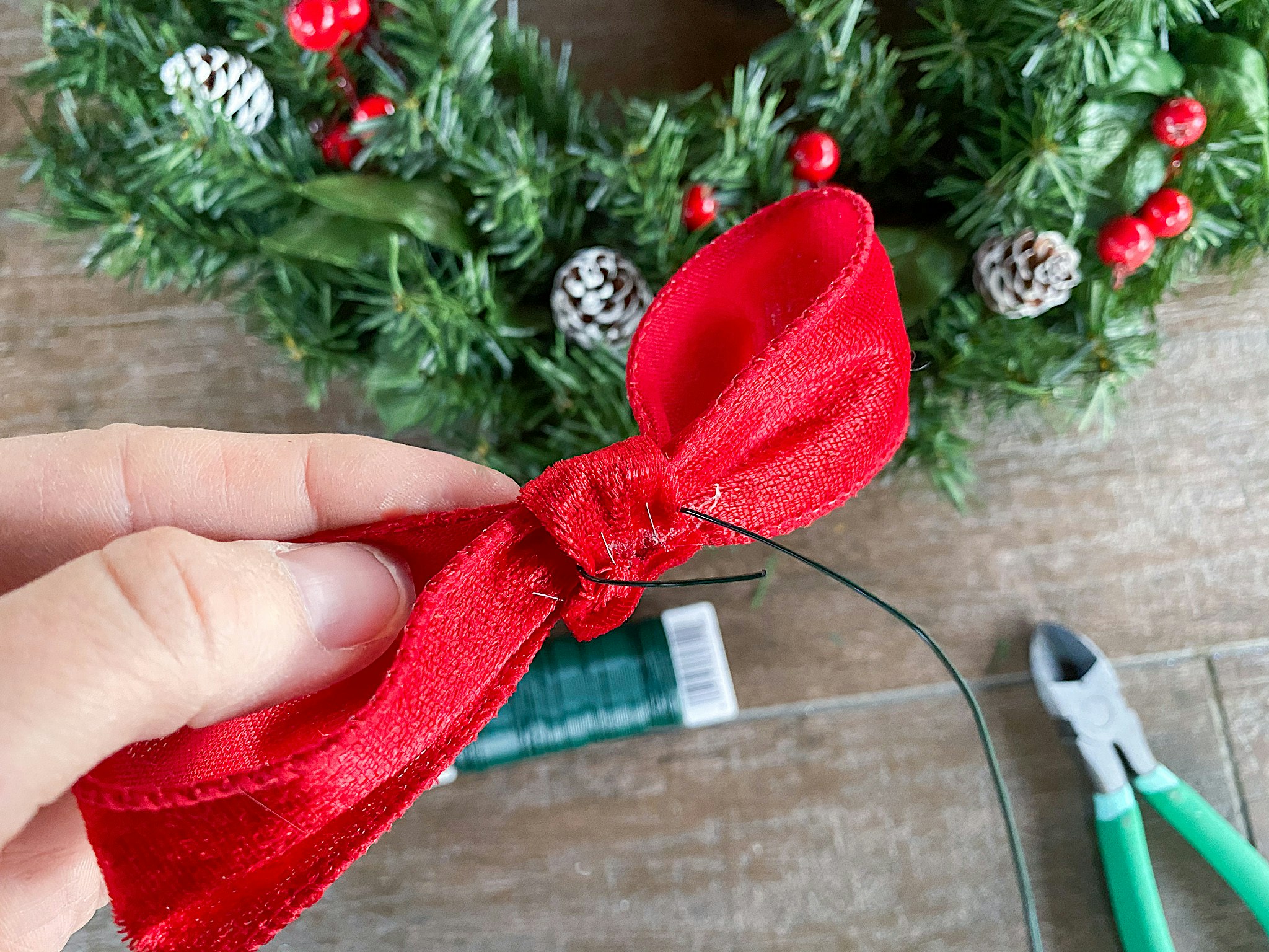 adding bows to wreath