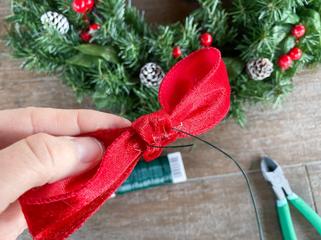 adding bows to wreath